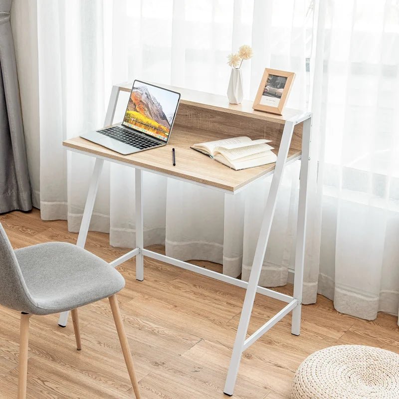 Modern wood and metal computer desk with laptop, book, and chair in bright home office
