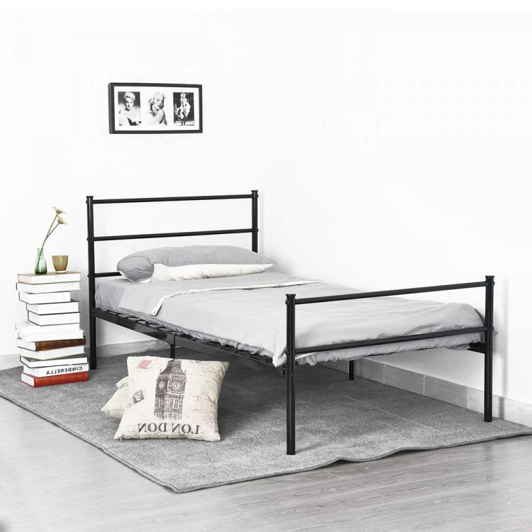 Minimalist black metal bed frame with grey bedding in modern bedroom setting