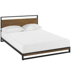 Modern platform bed with black metal frame, wood headboard, and white bedding.