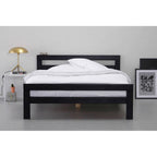 Modern black wooden bed frame with white bedding in minimalist bedroom