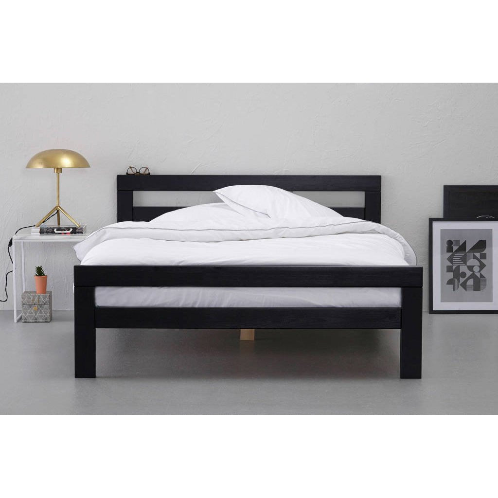 Modern black wooden bed frame with white bedding in minimalist bedroom