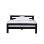 Black wooden bed frame with white bedding on a plain background