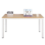 Modern wood and metal desk with a laptop, book, and teacup in a minimal home office setting