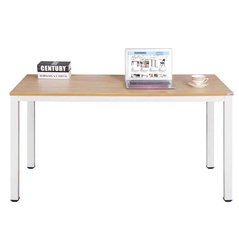 Modern wood and metal desk with a laptop, book, and teacup in a minimal home office setting