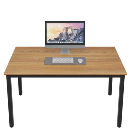 Minimalist wooden desk with black metal legs, computer, keyboard, and mouse on top