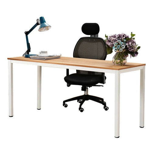 Modern office desk with light wood top, white legs, black mesh chair, lamp, and flowers