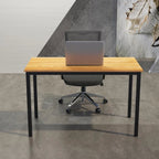 Modern office desk with wood top, metal legs, ergonomic chair, and laptop in contemporary workspace