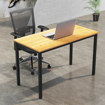 Modern office desk with natural wood top and black metal legs, mesh chair, and laptop
