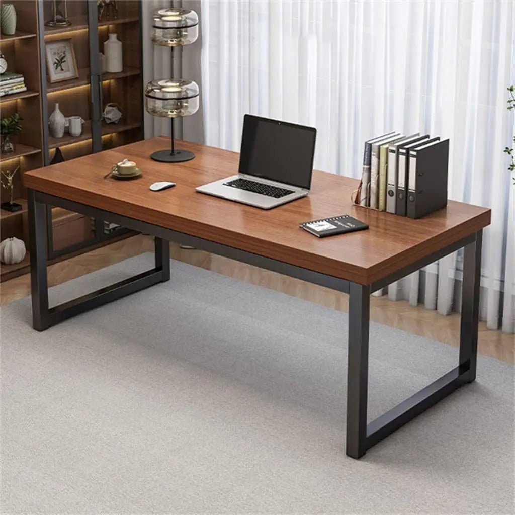 Modern black and brown office desk with metal legs, laptop, and workspace accessories