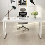 White modern office desk with mesh chair, table lamp, flowers, on light wood floor