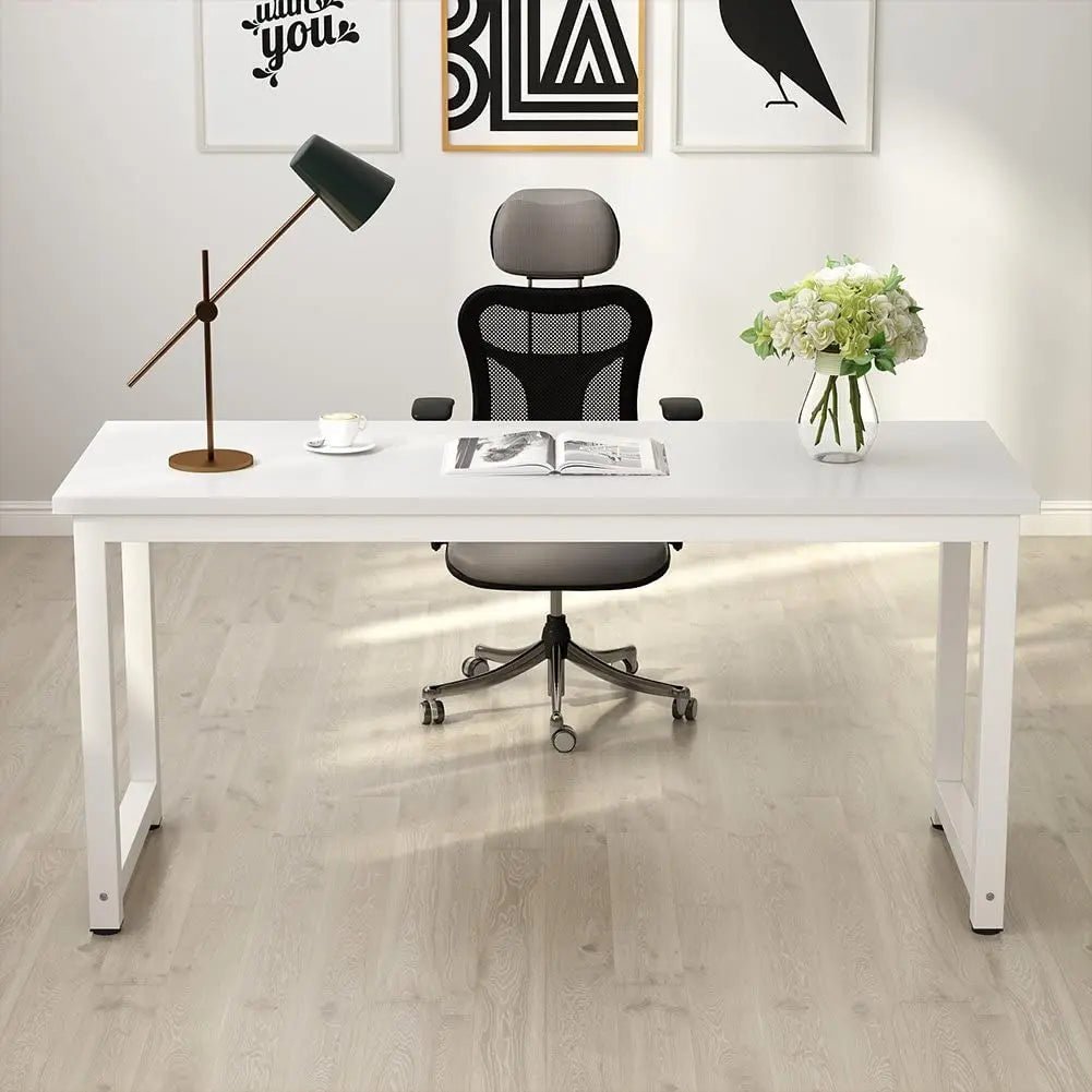 White modern office desk with mesh chair, table lamp, flowers, on light wood floor