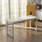 Modern white desk with metal legs in a sunlit home office on wooden flooring