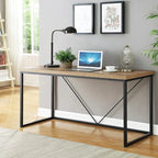Modern black and brown desk with metal frame, laptop, lamp, and plants in a home office
