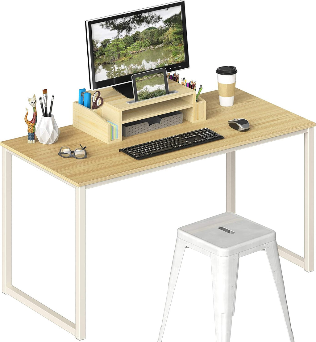 Modern office desk with wood top, white metal legs, monitor, organizer, and white stool