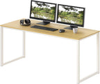 Modern office desk with light wood top, white metal legs, dual monitors, and computer accessories
