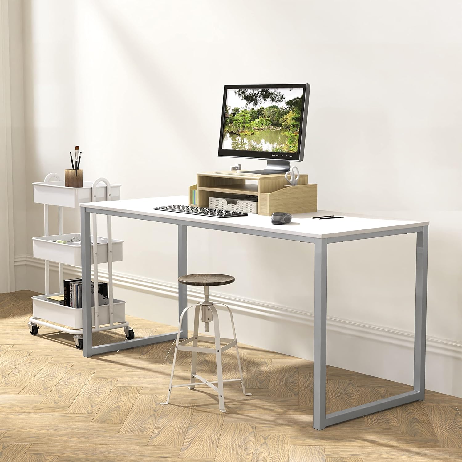 Modern office desk with metal frame, minimalist decor, and computer in a bright workspace