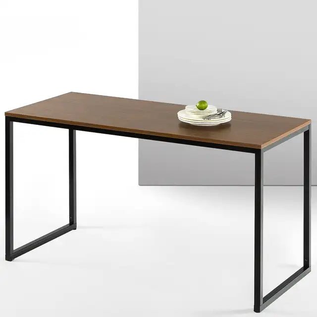 Modern wood desk with black metal legs in minimalist setting, plates and apple on top.