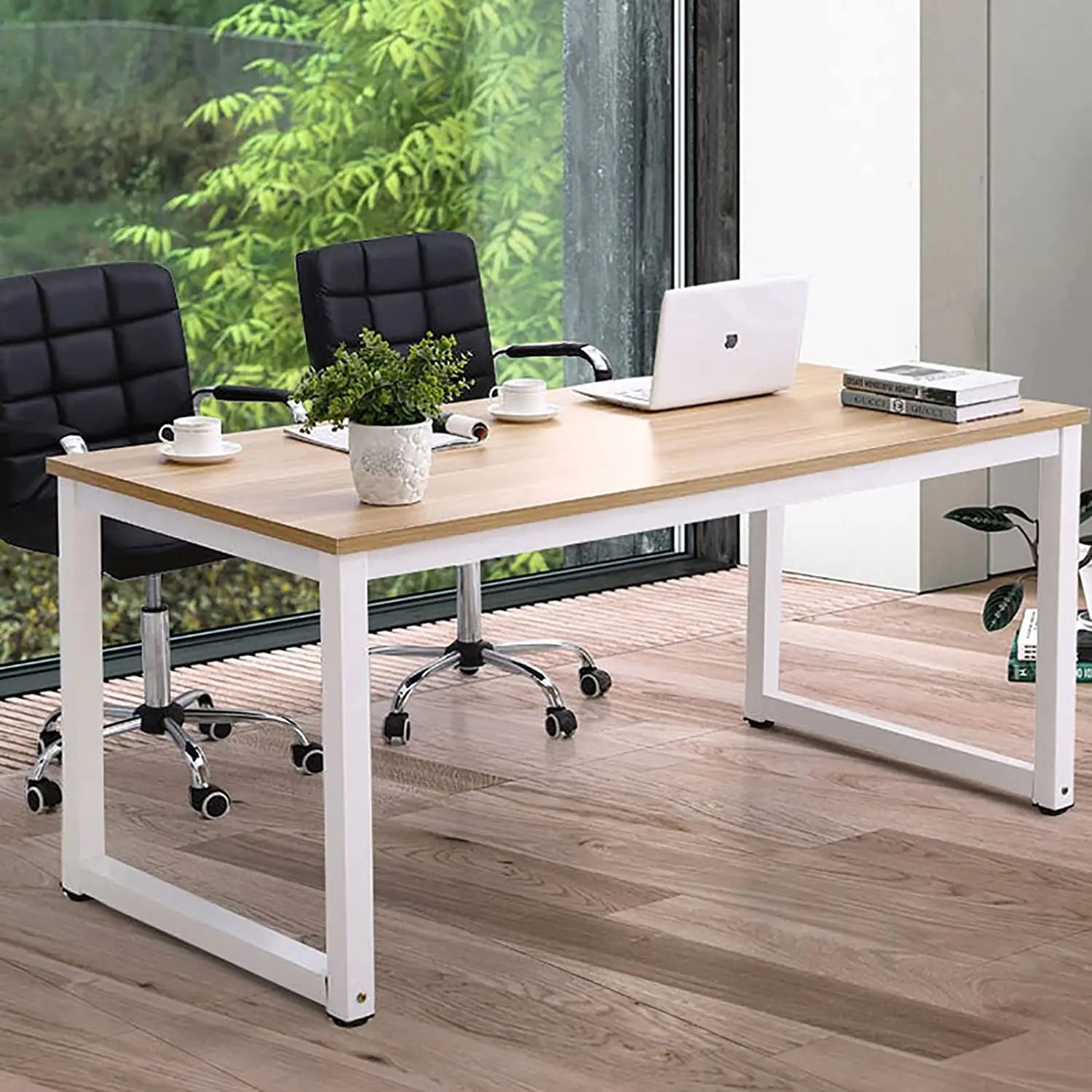 Modern metal desk with wooden top, office chairs, laptop, and plants in a bright workspace