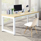 Modern office desk with wood top and white steel frame, styled with computer and chair for home workspace