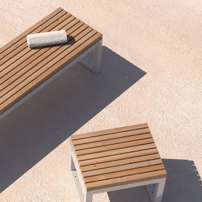 Modern outdoor backless bench and stool with wooden slats and metal frame on patio