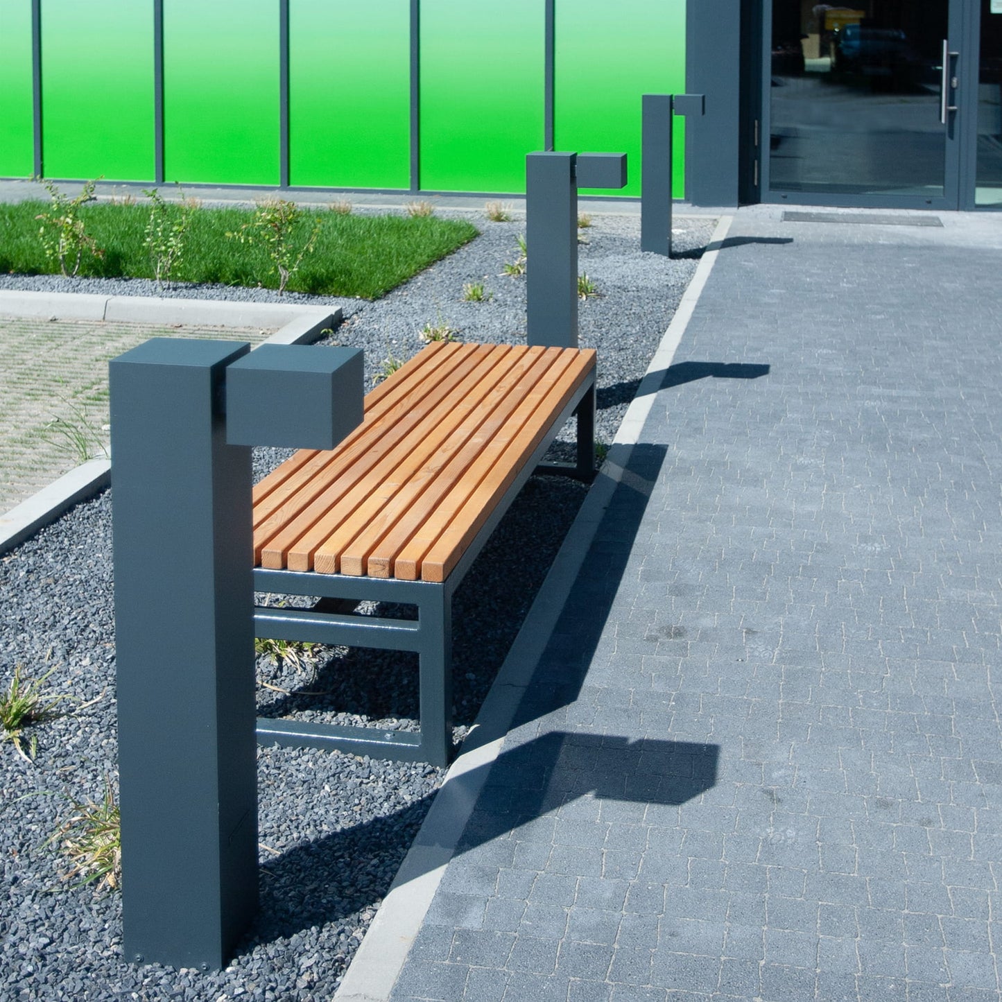 Modern 3-seater public backless bench with wooden slats and metal frame, outdoor setting