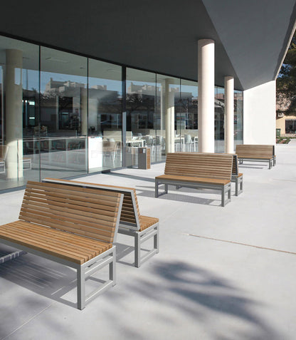 Outdoor three-seater benches with wooden slats and metal frames on a modern patio