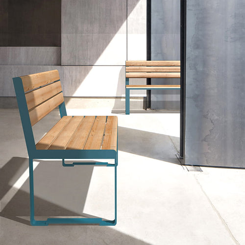 Modern 3-seater wooden bench with metal frame and backrest in a sunlit indoor setting