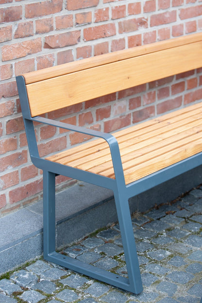 Modern 3-seater outdoor bench with wood slats, metal frame, and armrest by brick wall