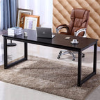 Modern black home office desk with metal frame, laptop, books, and brown chair on rug