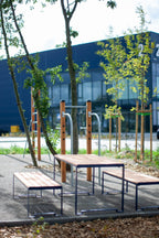 Sturdy outdoor table with benches for 4-6 seats in a modern park setting