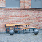 Outdoor 150 cm wooden table with metal frame and benches, seating 4-6, on brick patio