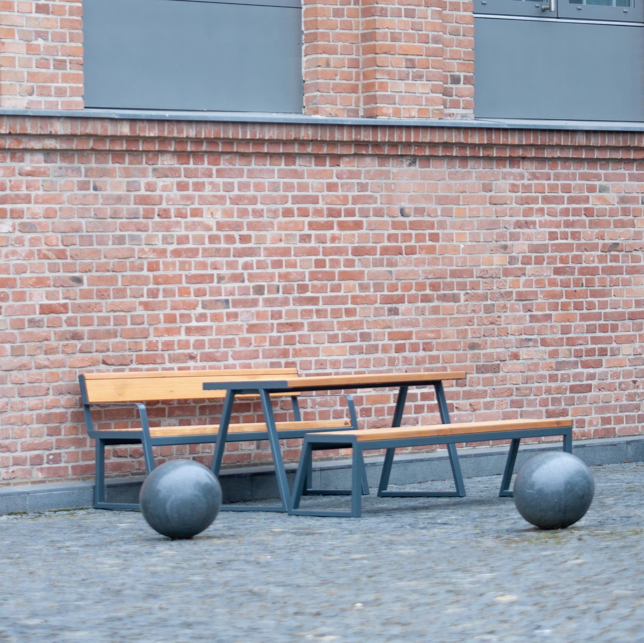 Outdoor 150 cm wooden table with metal frame and benches, seating 4-6, on brick patio