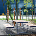 Outdoor sturdy table with benches, metal frame and wood slats, seating 4 to 6 people