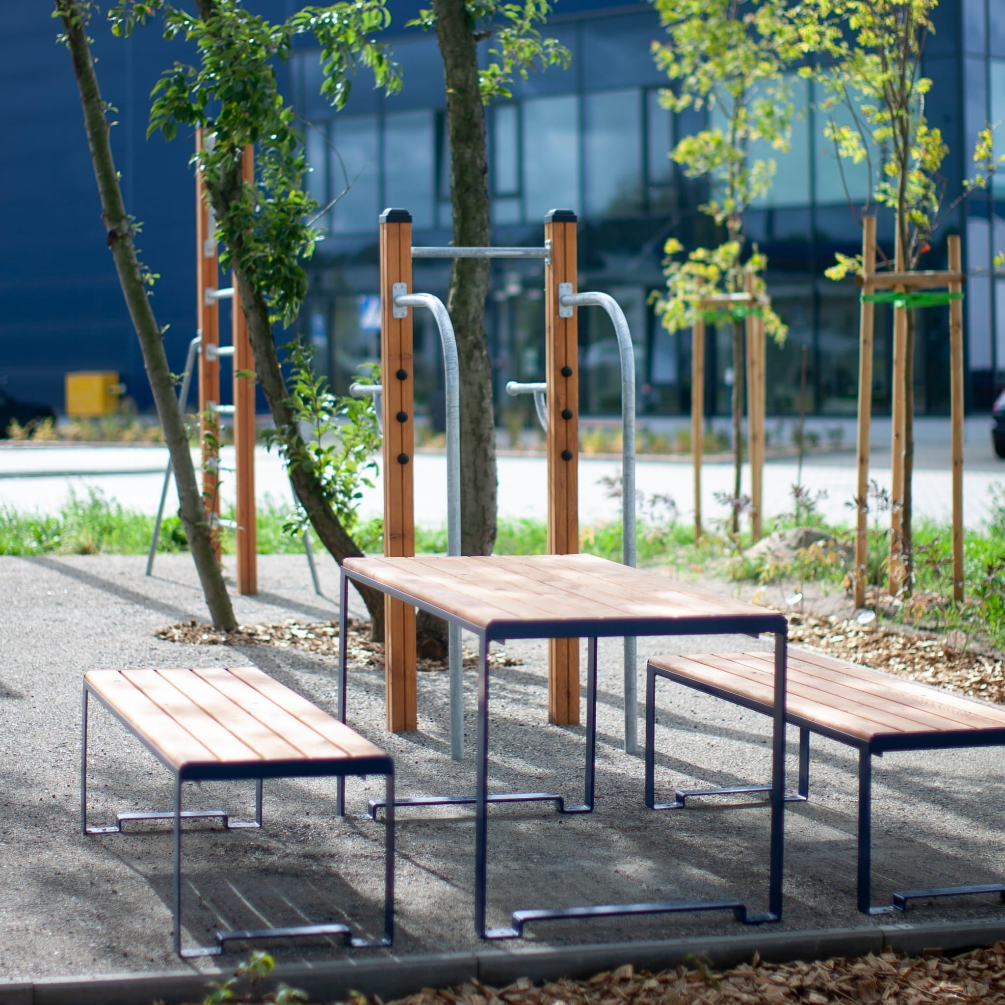 Outdoor sturdy table with benches, metal frame and wood slats, seating 4 to 6 people
