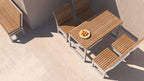 Modern outdoor wooden table set with four matching chairs and a bowl of fruit on patio