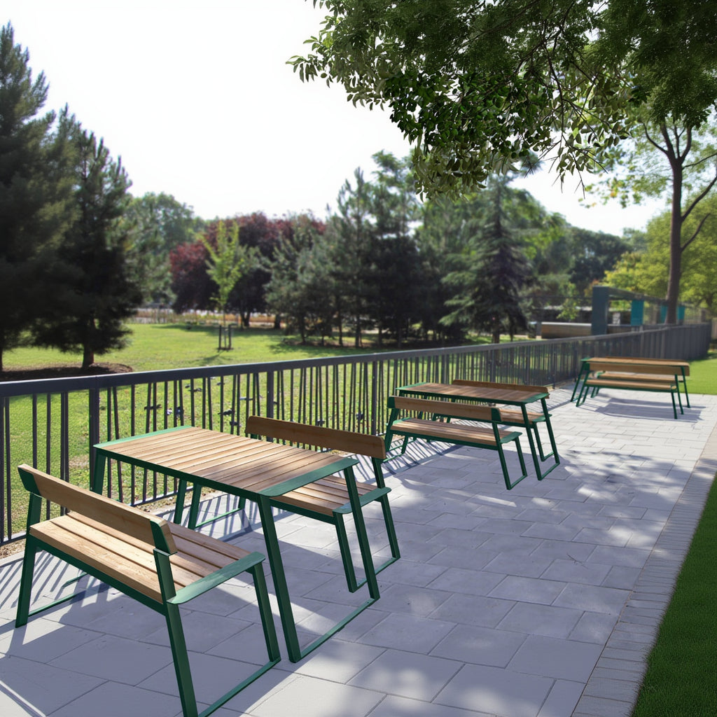 Outdoor wooden table with green metal frame and matching bench set on patio with park view