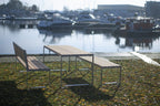 Modern outdoor wooden table with matching benches by a marina, seats 6 to 8 people