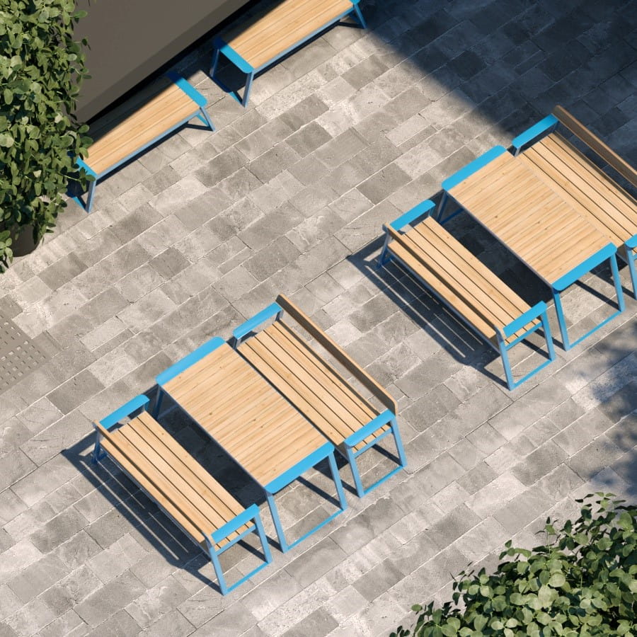 Outdoor rectangular wooden table with blue metal frame and matching benches on patio