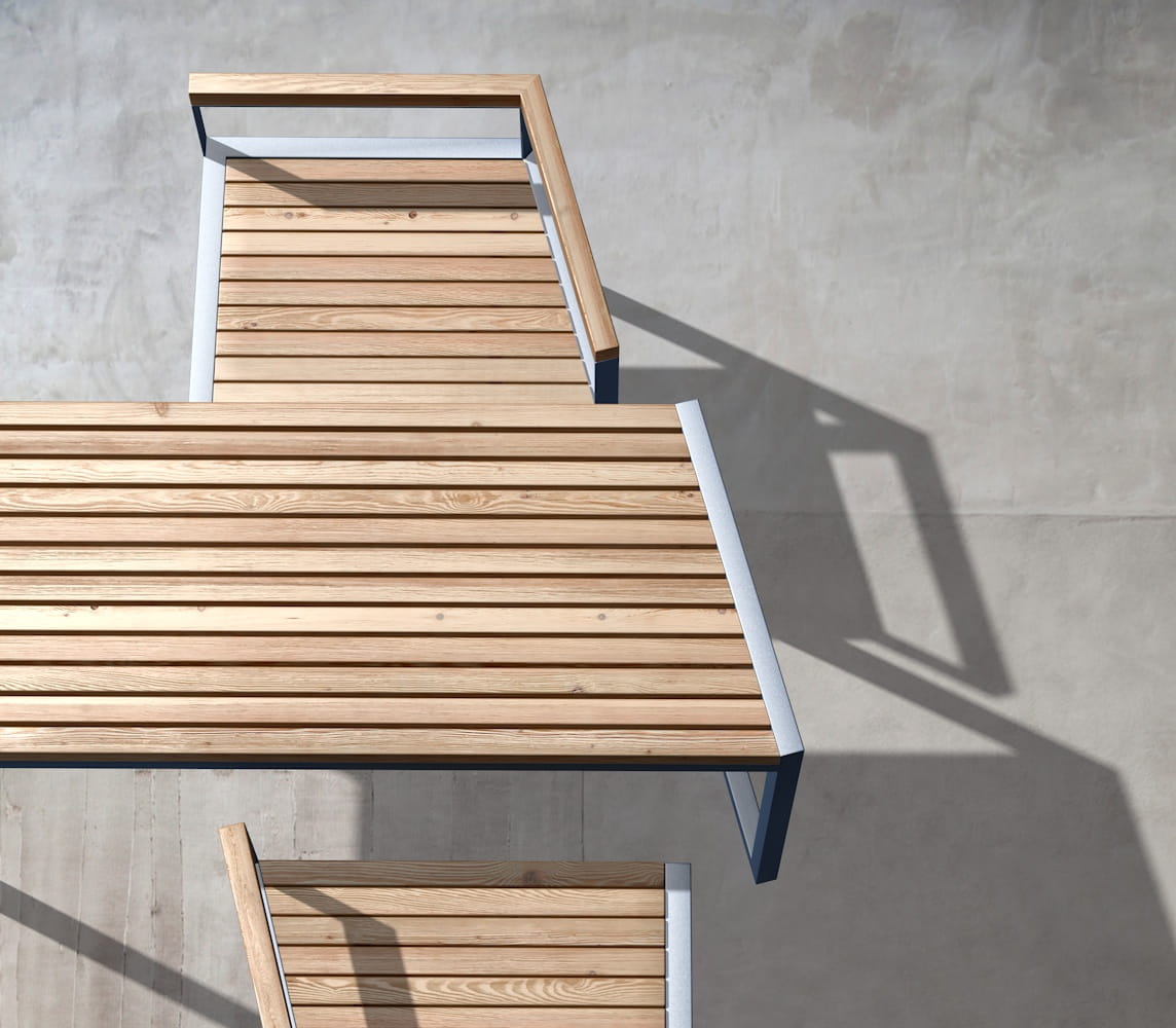 Modern outdoor wooden table and bench set with metal frame on concrete patio