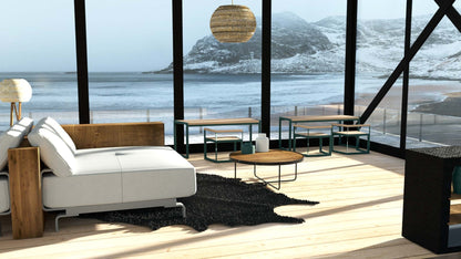 Modern outdoor table with seating for 6-8, set on wood deck overlooking snowy mountains.