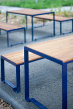 Outdoor table with sturdy metal frame and wooden top, designed for 6-8 seats