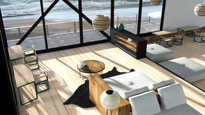 Modern outdoor dining area with wood tables, metal chairs, and ocean view through large windows