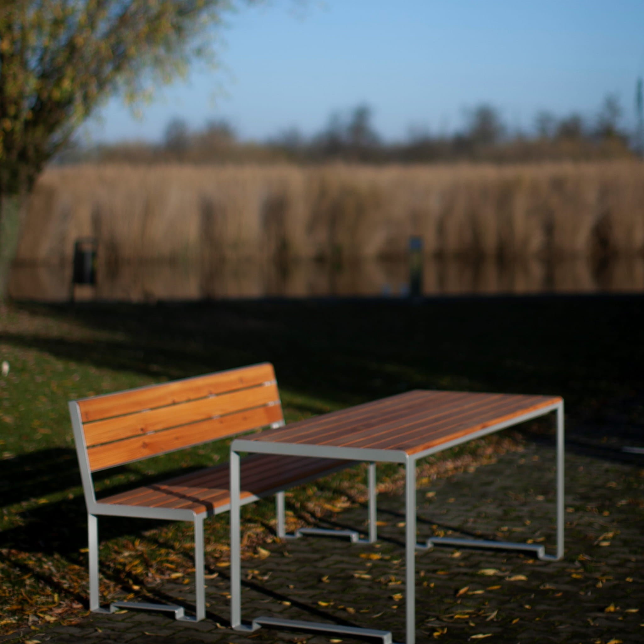 Modern 180 cm outdoor table with matching bench, metal frame, wood slats, garden setting