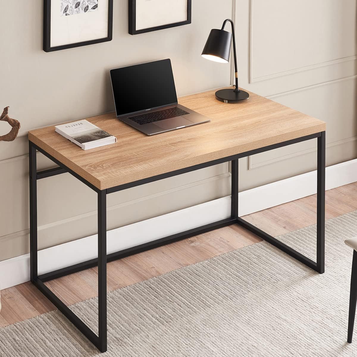Modern wood and metal desk with laptop, lamp, and decor in a stylish home office setting