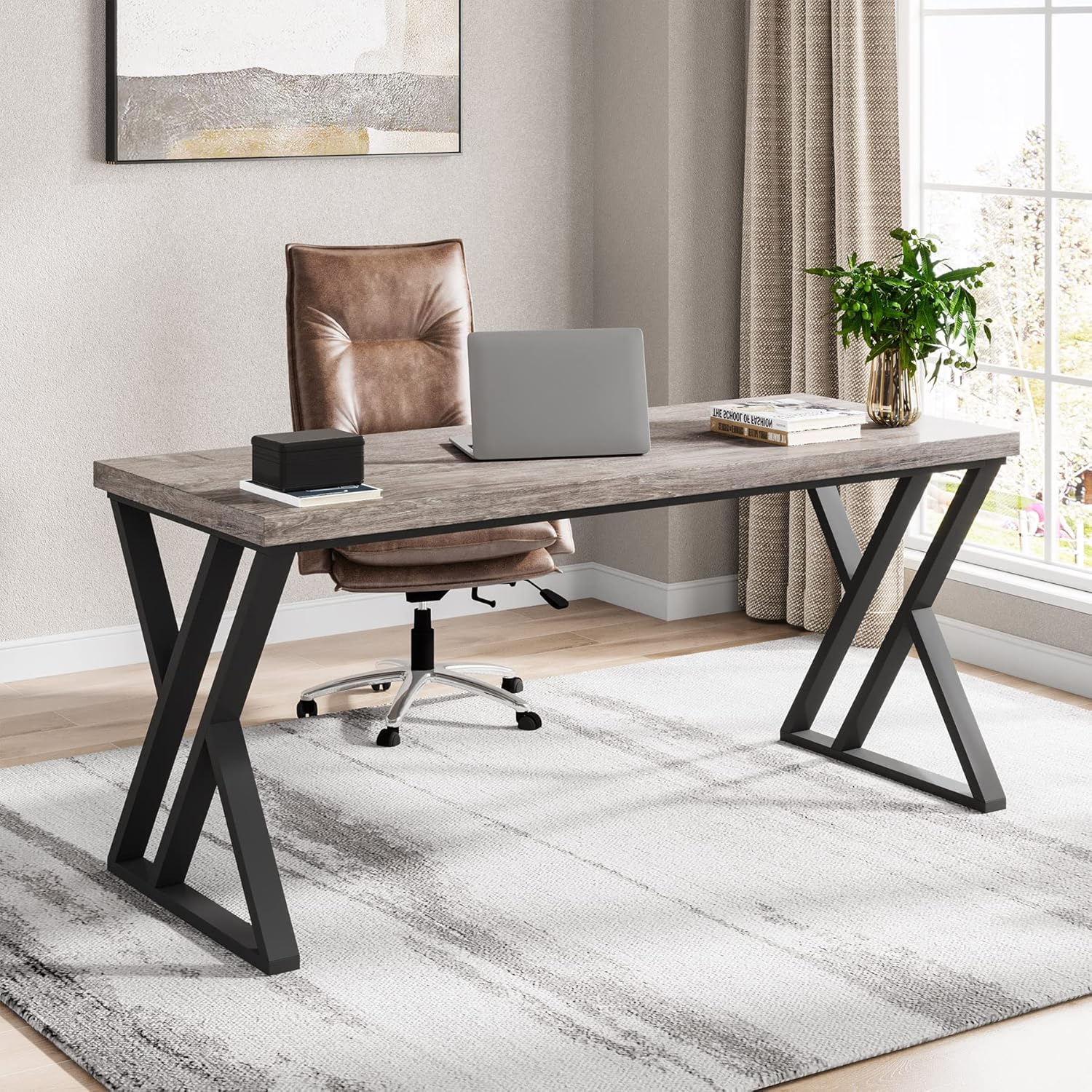Modern computer desk with metal legs in home office, featuring laptop and decor