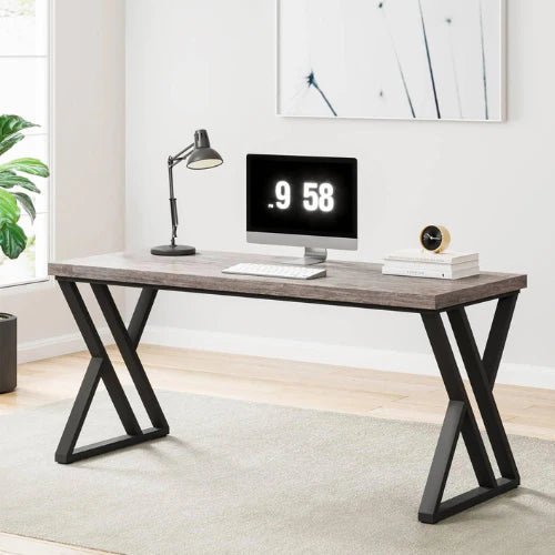 Modern computer desk with black metal legs, wood top, monitor, and lamp in a bright room